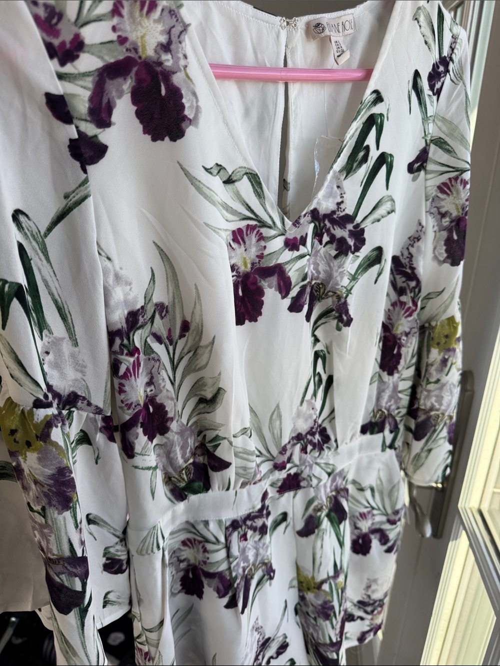 Purple Floral jumpsuit. Size 2. Features pockets and fluted sleeves.